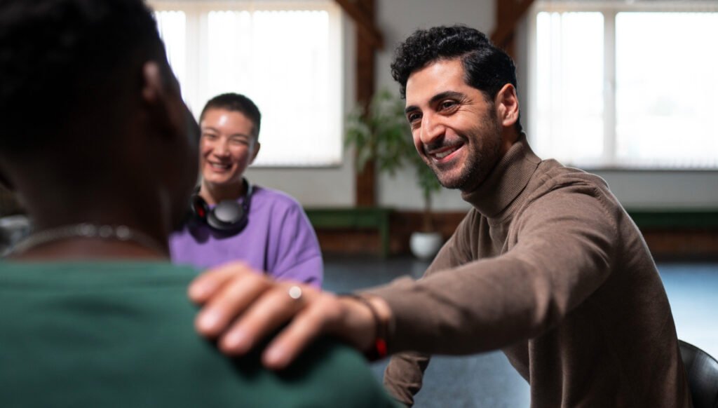 A supportive hand on the shoulder during a community support group